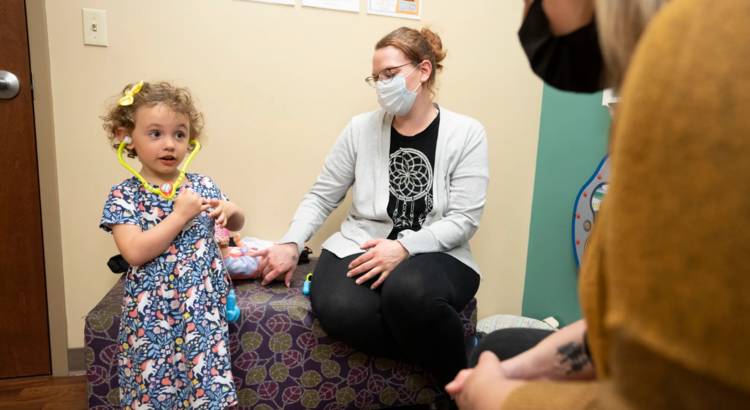 Young girl with mother at pediatrician visit