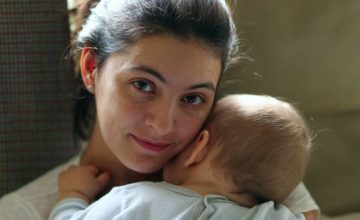 baby resting on mother