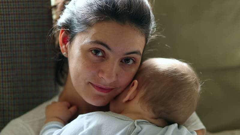 baby resting on mother