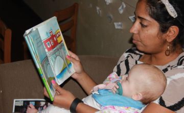 Teacher reading to a baby