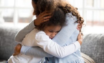 parent and young child hugging