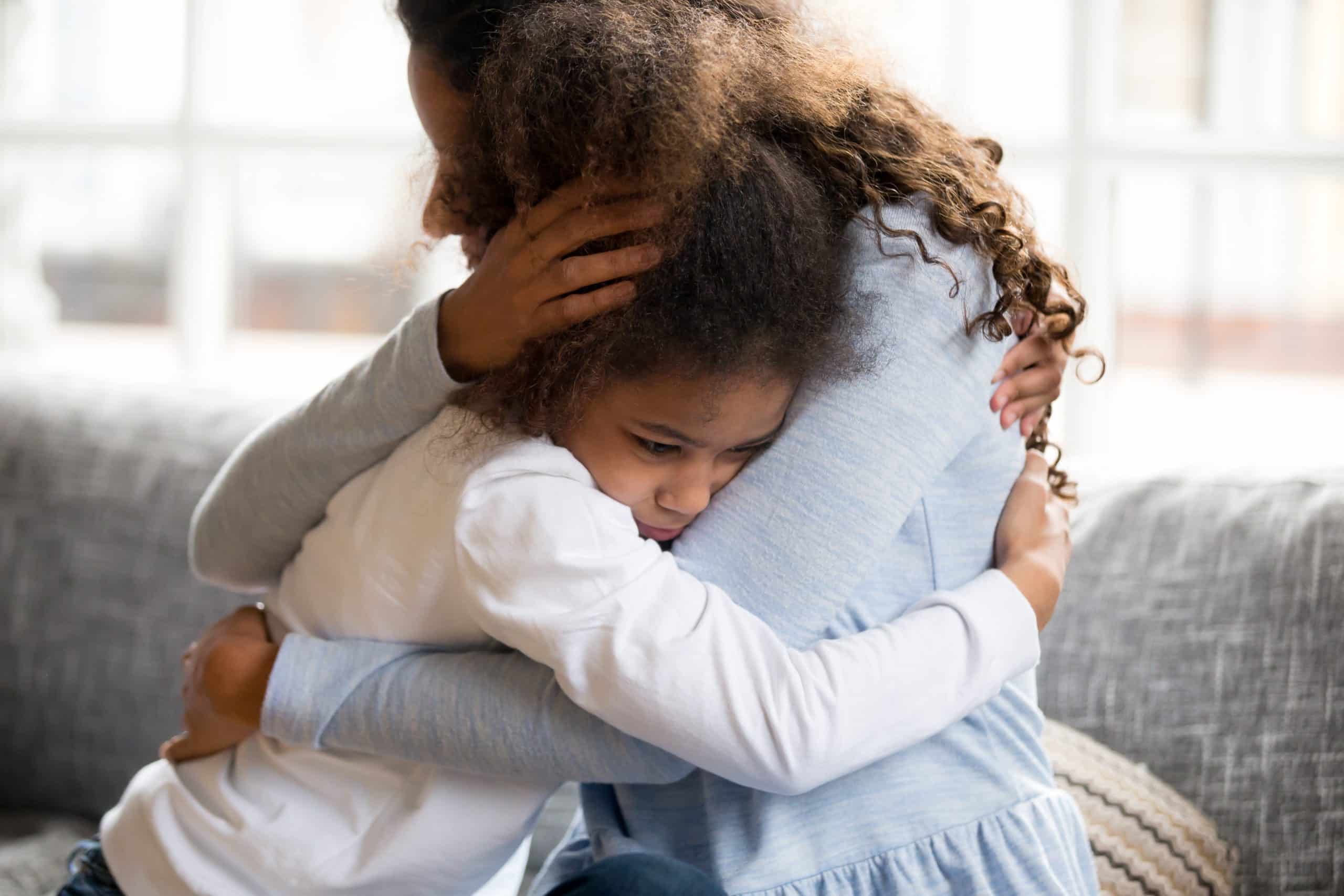 parent and young child hugging