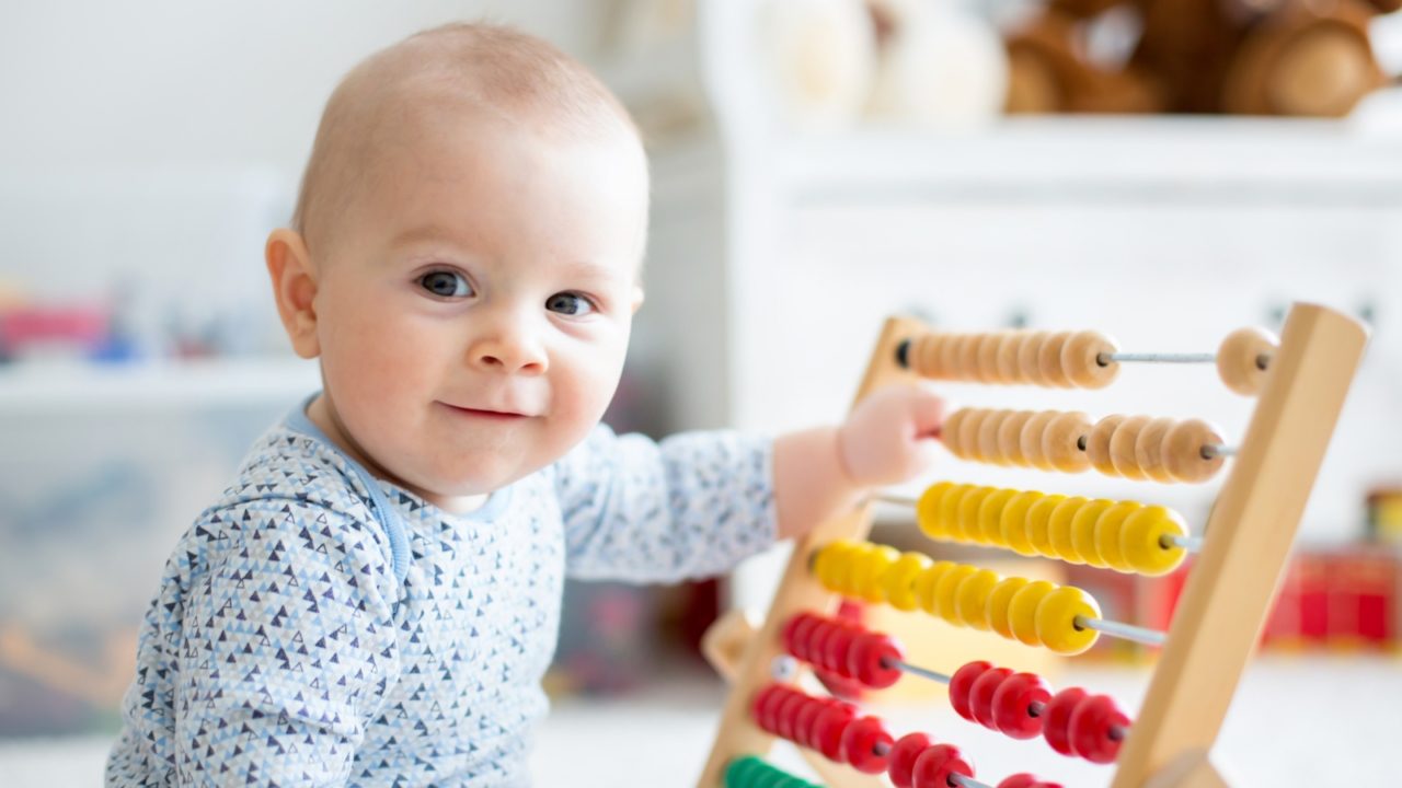 baby playing with abacus