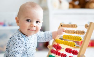 baby playing with abacus