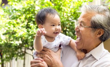 grandfather holding baby