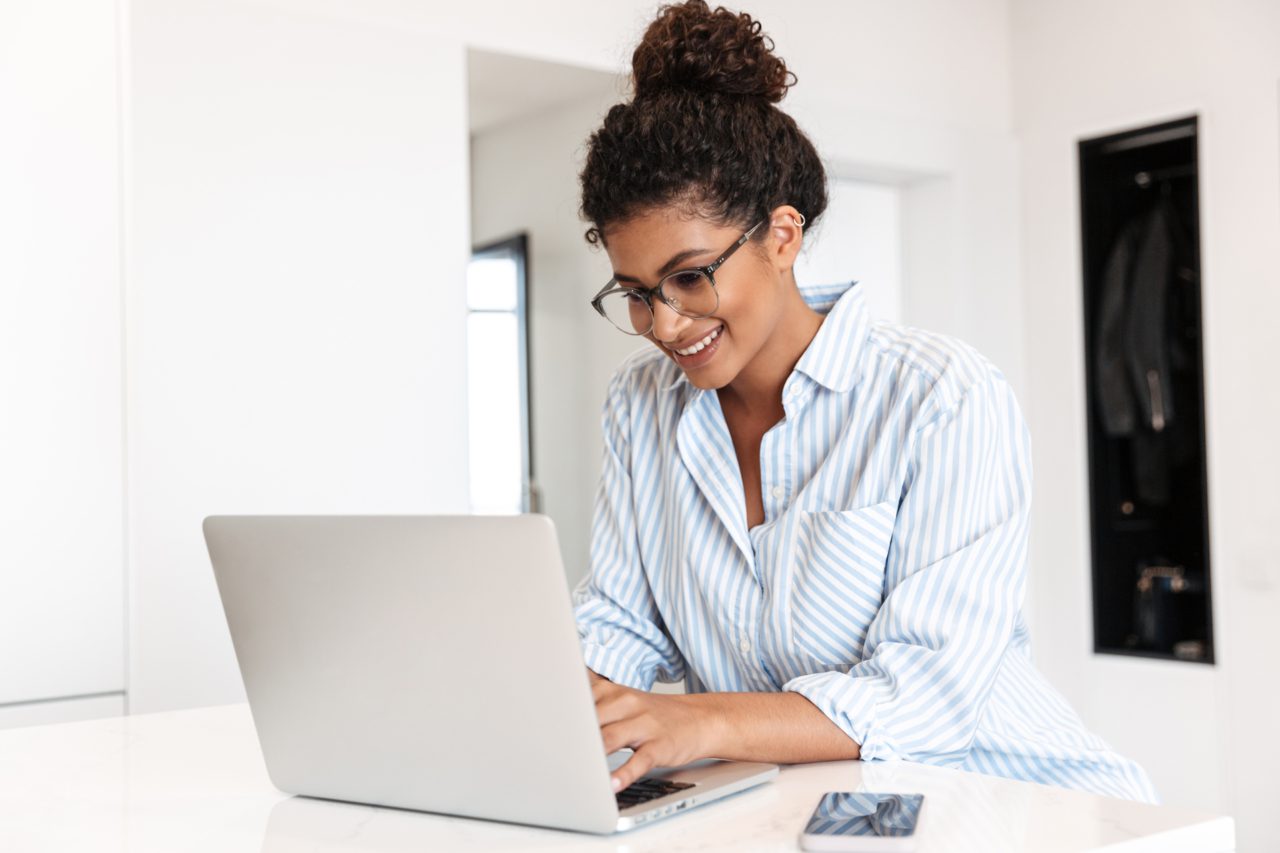 woman using laptop smiling
