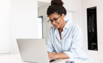 woman using laptop smiling