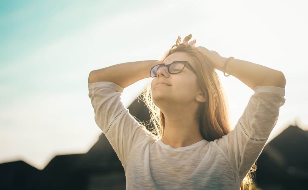 Woman with eyes closed smiling