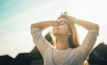 Woman with eyes closed smiling