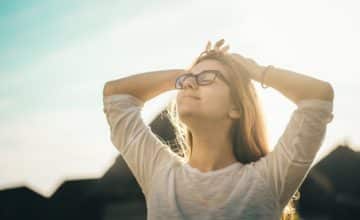 Woman with eyes closed smiling