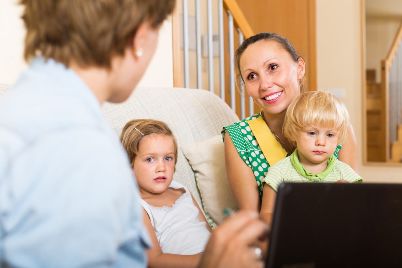 Professional talking to family at home