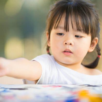 Toddler with paint brush