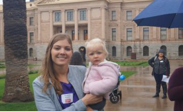 mom holding baby outside of arizona state capitol building
