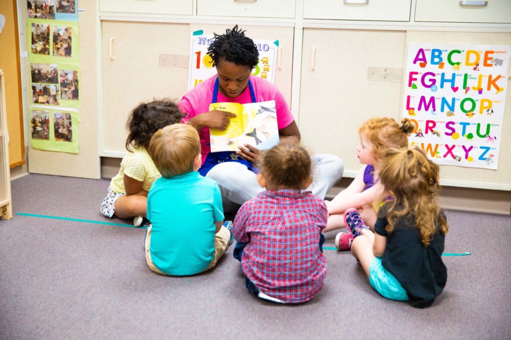 day care provider reading to toddlers