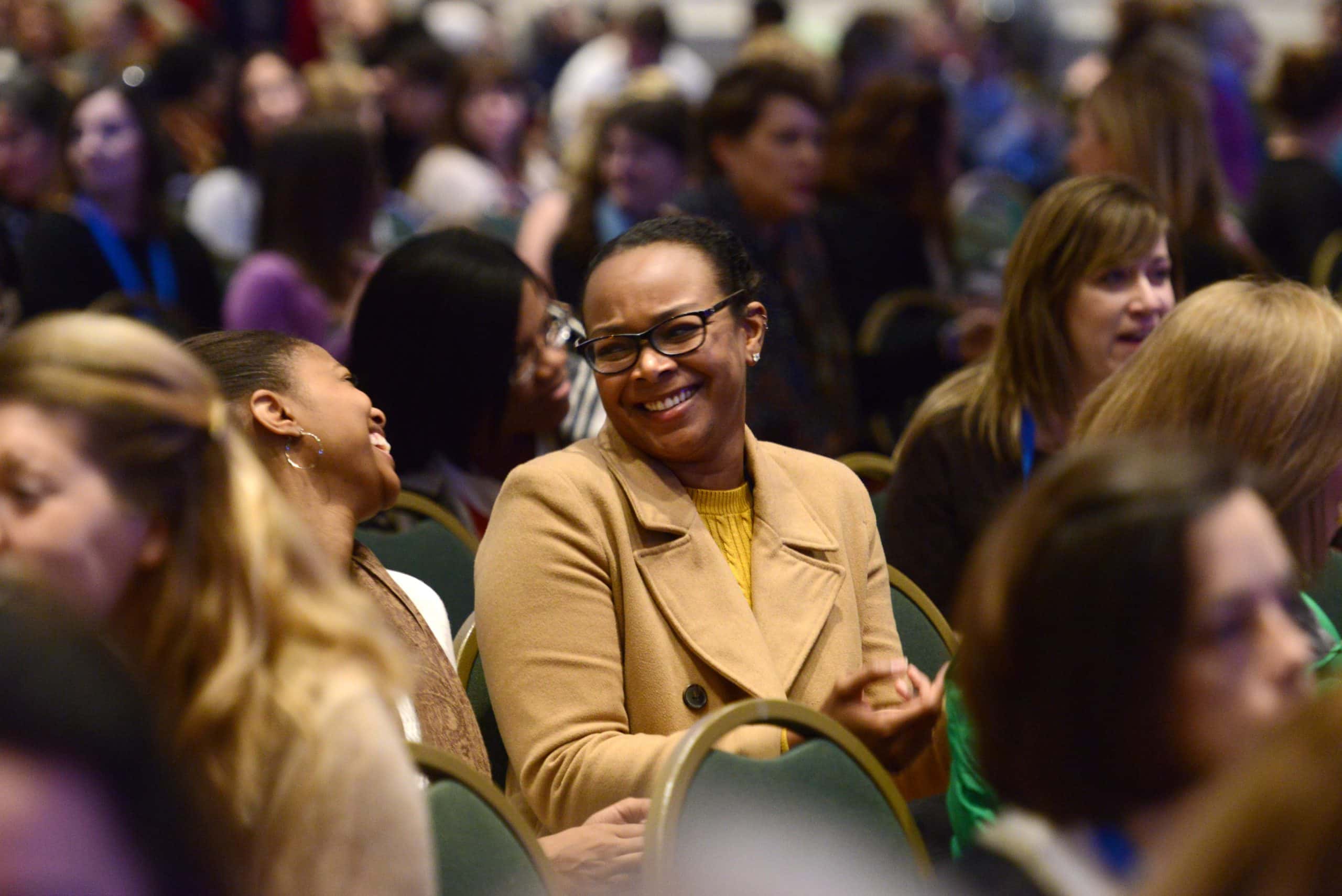 women sitting in audience at conference