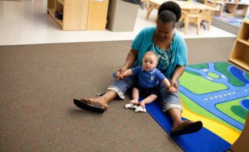 day care provider playing with baby
