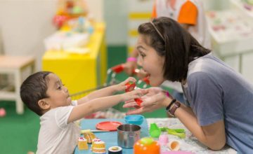 public pre-k instructor with child