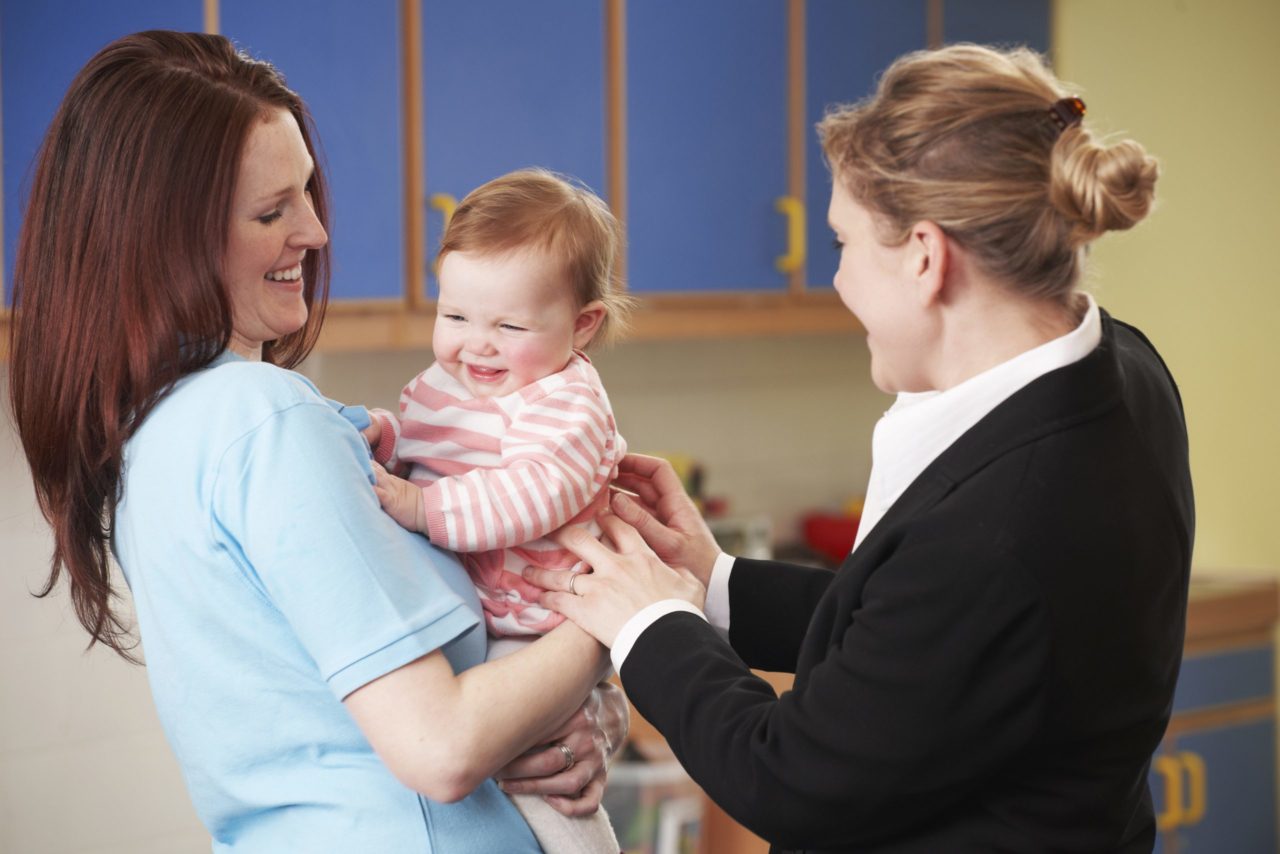 baby with mom and childcare provider