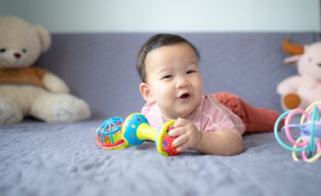 happy baby with toys