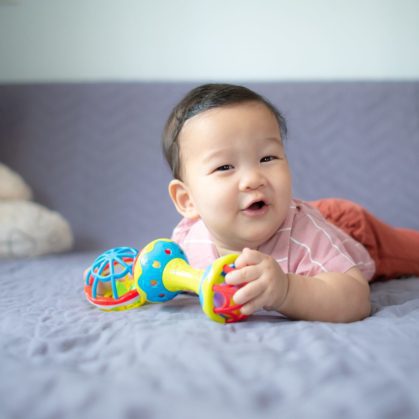happy baby with toys