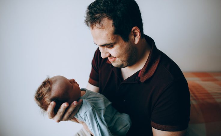 father holding baby