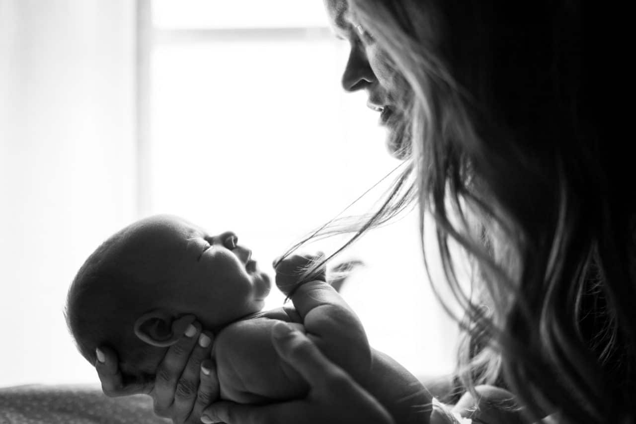 black and white mom holds baby