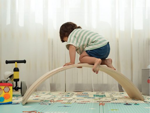 A child climbs and plays with toys