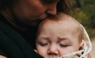 mother kisses baby's head