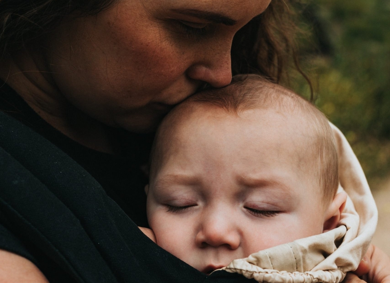 mother kisses baby's head