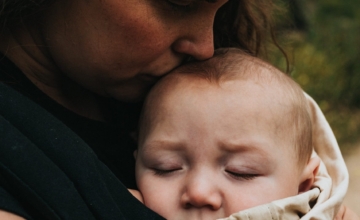 mother kisses baby's head