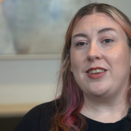 woman with long multi-color hair talking to camera