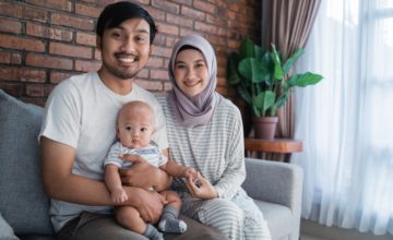 muslim asian parent playing at home with their baby