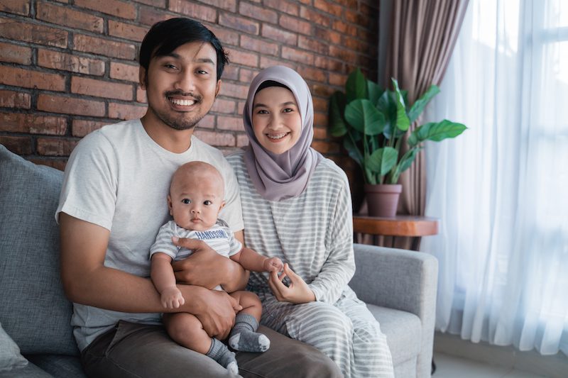 muslim asian parent playing at home with their baby