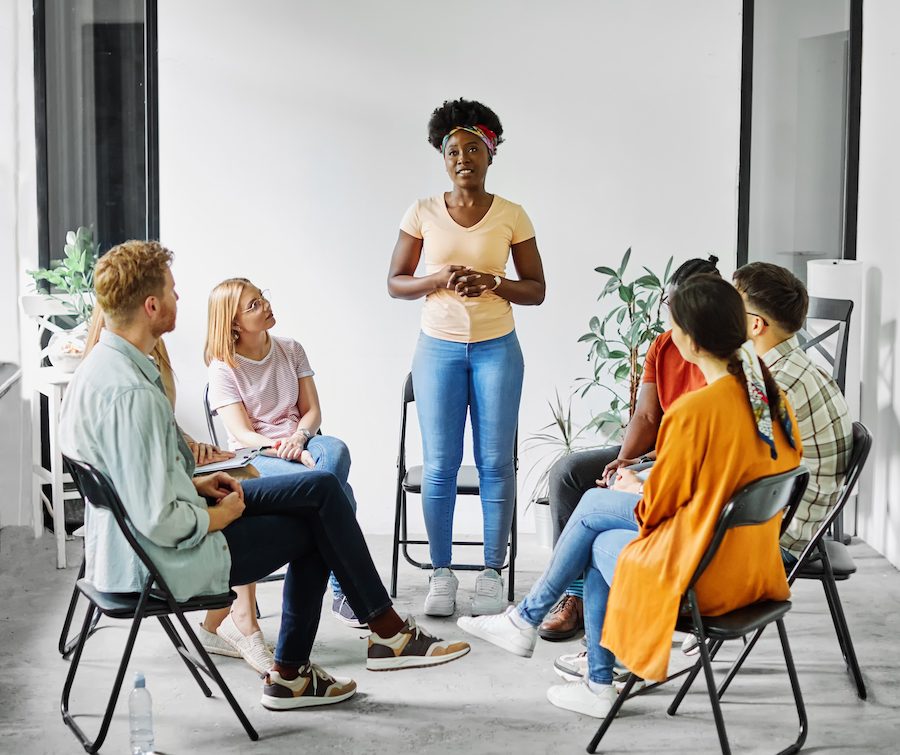 Group psychotherapy. Persons sitting in circle and talking. People meeting. Psychotherapy training, business lecture or conference. support group. meeting in the office