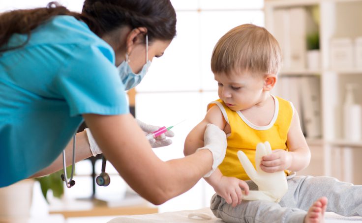 Female doctor makes a vaccination to a child