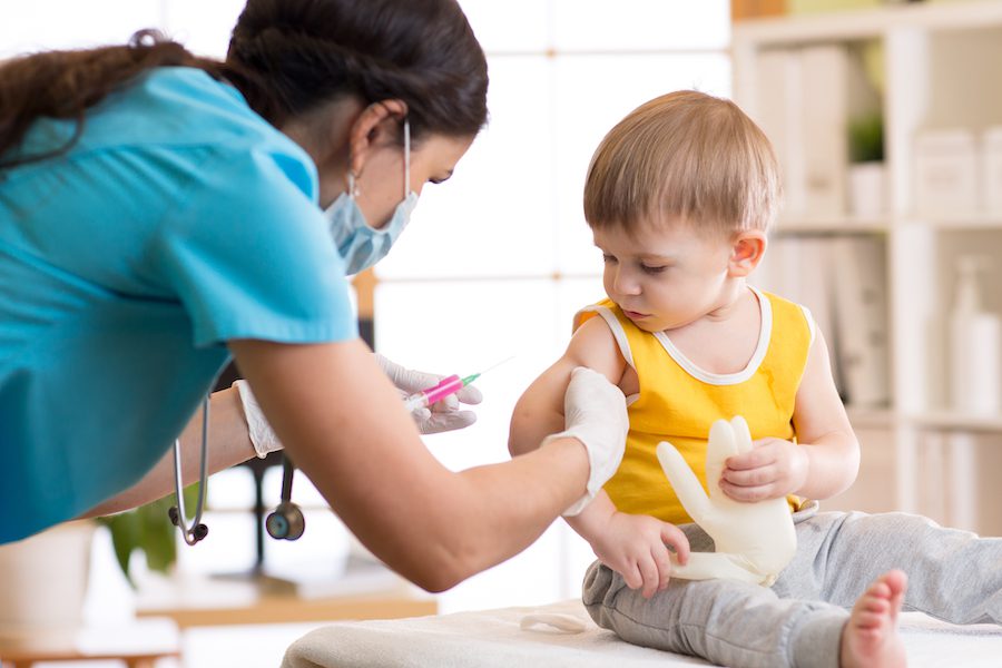 Female doctor makes a vaccination to a child