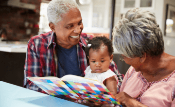 grandparents reading to infant