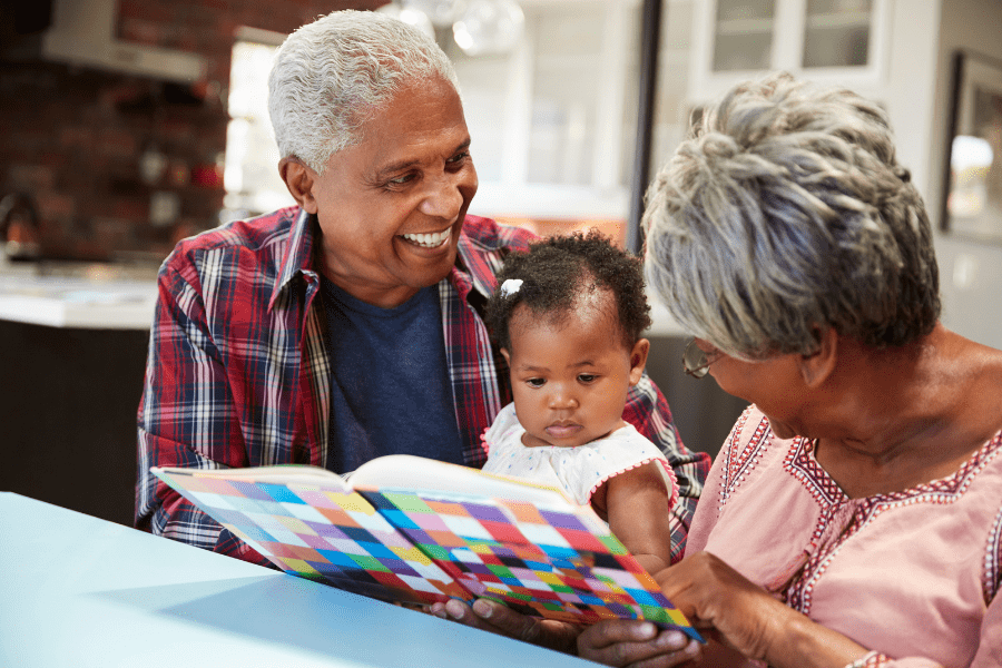 grandparents reading to infant