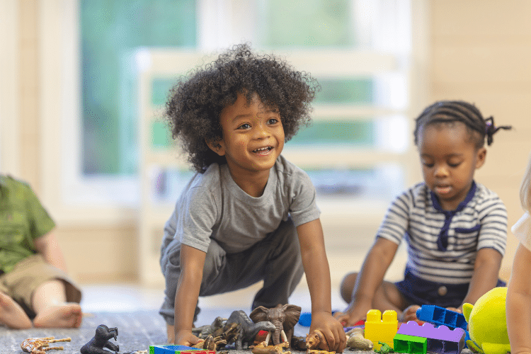 Toddler at child care with toys