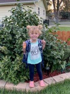 Carlie wearing a backpack ready for school