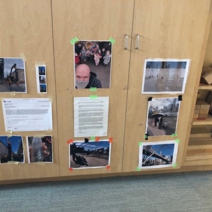 Preschool cubbies with photos taped to them.