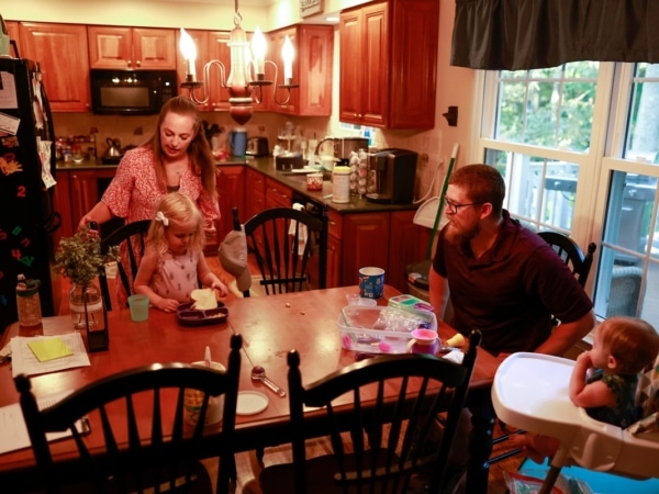 Family at the dinner table with a toddler and a baby