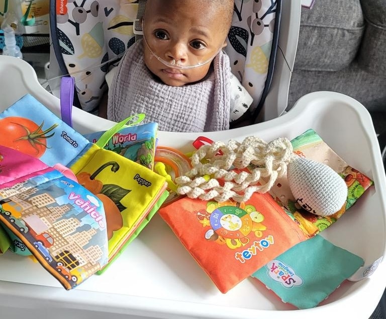 Milo in a high chair as a baby