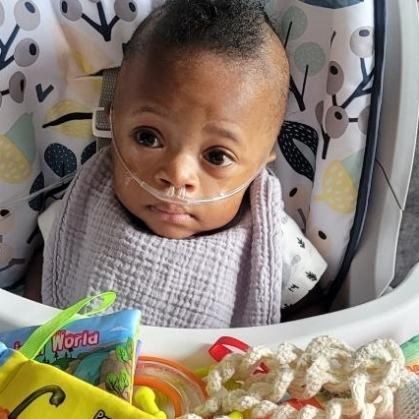 Milo in a high chair as a baby