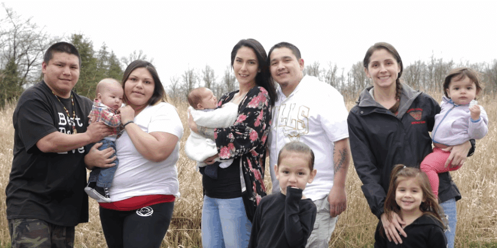 Native parents and their children smiling together