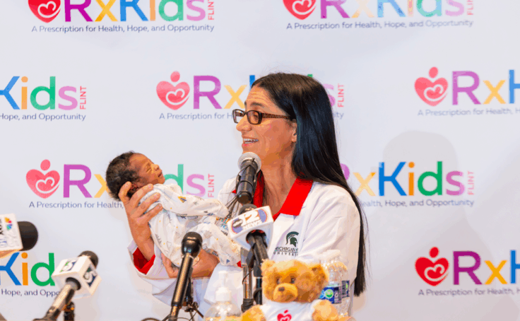 Dr. Mona holding a newborn baby