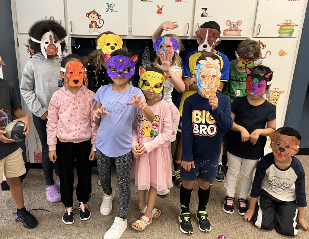 A class of young children wearing animal masks