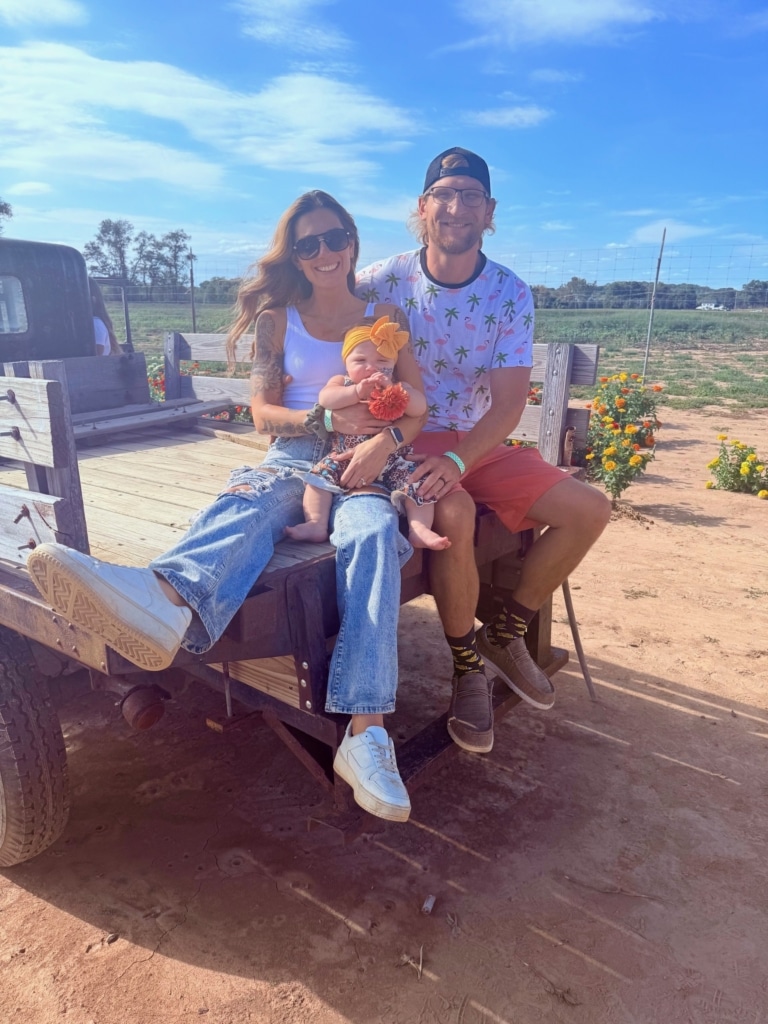 Ashley and her daughter sitting outside and smiling