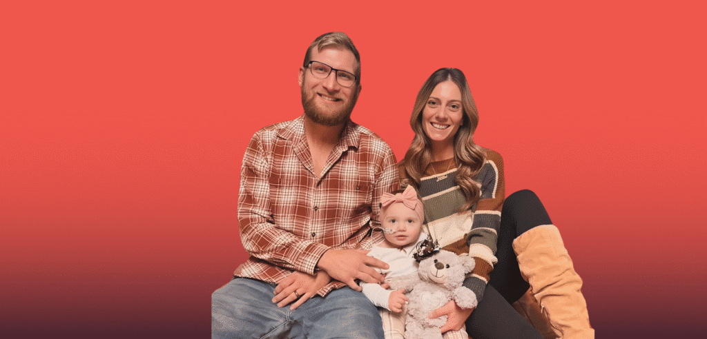 Ashley and her family sitting on the floor smiling
