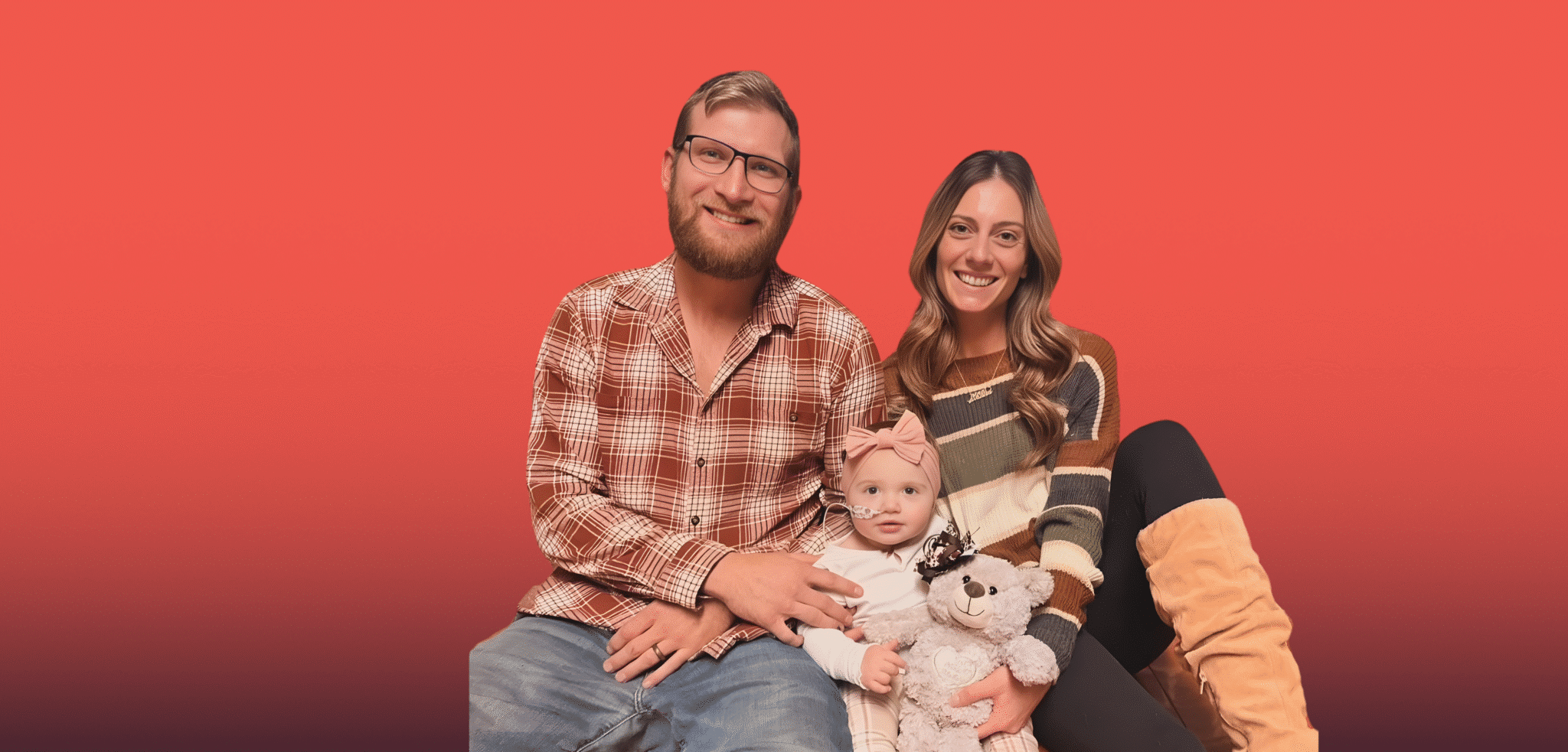 Ashley and her family sitting on the floor smiling